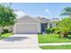 Charming single-story home featuring a well-manicured lawn and a two-car garage at 1748 Savannah Ln, Port Orange, FL 32128