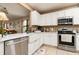 Bright kitchen with white cabinets, stainless steel appliances, and a farmhouse-style sink at 1748 Savannah Ln, Port Orange, FL 32128