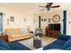 Inviting living room featuring warm paint, ceiling fan and a TV at 1748 Savannah Ln, Port Orange, FL 32128