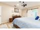 Cozy bedroom with a wood dresser, a sliding barn door to the bathroom, and light-colored walls at 1748 Savannah Ln, Port Orange, FL 32128