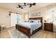 Charming bedroom showcasing a barn door to the bathroom, wood-framed bed, and stylish décor at 1748 Savannah Ln, Port Orange, FL 32128