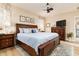 Beautiful bedroom featuring a wood-framed bed with a light blue quilt, wood nightstands, and a ceiling fan at 1748 Savannah Ln, Port Orange, FL 32128