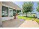 Covered patio area, leading to a well-maintained lawn and partial pond view in the backyard at 1748 Savannah Ln, Port Orange, FL 32128