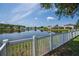 Scenic pond view from the backyard, surrounded by lush greenery and residential homes at 1748 Savannah Ln, Port Orange, FL 32128