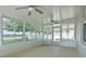 Enclosed sunroom featuring ceiling fans and picturesque views of the surrounding landscape at 1748 Savannah Ln, Port Orange, FL 32128