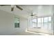 Bright sunroom with multiple ceiling fans and large windows, perfect for relaxation at 1748 Savannah Ln, Port Orange, FL 32128