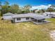 Aerial view of the home showcasing the covered back patio, detached garage, and large yard at 1812 Bayview Dr, New Smyrna Beach, FL 32168