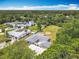 Aerial view shows this single story home has a large backyard, mature trees, and neighborhood pool at 1812 Bayview Dr, New Smyrna Beach, FL 32168