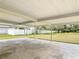 The covered back patio is perfect for entertaining and has views of the grassy backyard and white fence at 1812 Bayview Dr, New Smyrna Beach, FL 32168