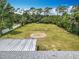 A bird's eye view of the fenced backyard with lush trees and greenery that offers privacy at 1812 Bayview Dr, New Smyrna Beach, FL 32168