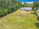 Expansive backyard featuring ample green space and a covered patio, perfect for outdoor activities at 1812 Bayview Dr, New Smyrna Beach, FL 32168