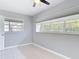 Neutral bedroom with tile flooring, two windows, and a ceiling fan at 1812 Bayview Dr, New Smyrna Beach, FL 32168