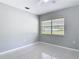 Bedroom showcasing tile flooring, a ceiling fan, and a bright window at 1812 Bayview Dr, New Smyrna Beach, FL 32168