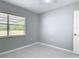 Bedroom features tile flooring, bright light, and an open window at 1812 Bayview Dr, New Smyrna Beach, FL 32168