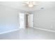 This bedroom has tile floors, a ceiling fan, and two doors leading to other rooms in the home at 1812 Bayview Dr, New Smyrna Beach, FL 32168