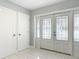 Welcoming foyer with decorative glass front door, tile flooring, and two hallway closets at 1812 Bayview Dr, New Smyrna Beach, FL 32168