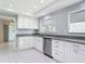 Modern kitchen featuring white cabinets, granite countertops, and stainless steel appliances at 1812 Bayview Dr, New Smyrna Beach, FL 32168