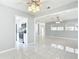 Open-concept living room with tile flooring and access to the kitchen with stainless steel appliances at 1812 Bayview Dr, New Smyrna Beach, FL 32168
