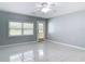 Bright, spacious living room with tile flooring, window, and exterior access at 1812 Bayview Dr, New Smyrna Beach, FL 32168
