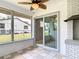 The patio features a screened enclosure, white brick fireplace, and views of the fenced backyard at 1812 Bayview Dr, New Smyrna Beach, FL 32168