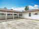 Covered patio area with brick accents, tiled flooring, and access to the main house at 1812 Bayview Dr, New Smyrna Beach, FL 32168