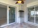 View of the patio with outdoor brick fireplace and sliding glass doors that lead to the interior of the home at 1812 Bayview Dr, New Smyrna Beach, FL 32168