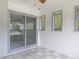 The sun room features sliding glass doors to the exterior of the home and tile floors at 1812 Bayview Dr, New Smyrna Beach, FL 32168