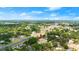 Aerial view of property in a neighborhood with mature trees and paved roads at 1851 Needle Palm Dr, Edgewater, FL 32141