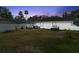 Spacious backyard with a patio set, BBQ, and lush green grass at 1851 Needle Palm Dr, Edgewater, FL 32141