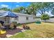 This house features a lovely backyard with a brick patio, ideal for entertaining, and lush green grass at 1851 Needle Palm Dr, Edgewater, FL 32141