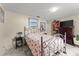 Bedroom with flamingo-themed bedding, adjacent to bookcase and television at 1851 Needle Palm Dr, Edgewater, FL 32141