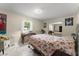 Bedroom with a window, desk, flamingo bedding and mirrored closet doors at 1851 Needle Palm Dr, Edgewater, FL 32141