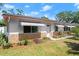 Single-story home with a well-manicured lawn and vibrant landscaping at 1851 Needle Palm Dr, Edgewater, FL 32141