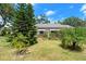 Well-maintained front yard with mature trees and beautiful landscaping at 1851 Needle Palm Dr, Edgewater, FL 32141