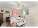 Serene main bedroom features a floral bedspread, bedside tables, and a convenient ensuite bathroom at 1851 Needle Palm Dr, Edgewater, FL 32141