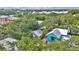 Aerial view of the home surrounded by lush trees in a vibrant coastal community at 209 Esther St, New Smyrna Beach, FL 32169