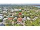 Aerial view of the home nestled among trees in a neighborhood near the water at 209 Esther St, New Smyrna Beach, FL 32169