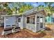 Backyard featuring a sitting area, complemented by a cozy outdoor space and mature trees at 209 Esther St, New Smyrna Beach, FL 32169
