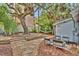 Backyard featuring an outdoor seating area with mature trees, perfect for relaxing and entertaining at 209 Esther St, New Smyrna Beach, FL 32169