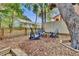 A peaceful backyard with Adirondack chairs, mature trees and a charming picket fence creating a cozy outdoor retreat at 209 Esther St, New Smyrna Beach, FL 32169