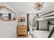 Bedroom featuring a bunk bed, mounted tv, wood-look flooring, and natural light from the window at 209 Esther St, New Smyrna Beach, FL 32169