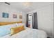 Bright bedroom featuring a white walls, chandelier, comfortable bed, and colorful decor at 209 Esther St, New Smyrna Beach, FL 32169