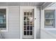 Charming front entrance featuring a glass-paneled door and well-maintained exterior at 209 Esther St, New Smyrna Beach, FL 32169