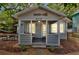 Inviting front porch of a charming single-story home with a quaint seating area and tasteful decor at 209 Esther St, New Smyrna Beach, FL 32169