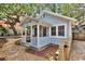 Charming cottage-style home featuring a cozy porch and quaint wooden fence at 209 Esther St, New Smyrna Beach, FL 32169