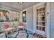 Charming front porch with seating area, colorful rug, and inviting entryway at 209 Esther St, New Smyrna Beach, FL 32169
