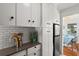 Bright kitchen with stainless steel appliances and modern white cabinetry at 209 Esther St, New Smyrna Beach, FL 32169