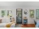 Cozy living room with hardwood floors and a glass pane front door at 209 Esther St, New Smyrna Beach, FL 32169