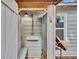 Quaint outdoor shower with white painted wood and vintage fixtures, perfect for rinsing off after the beach at 209 Esther St, New Smyrna Beach, FL 32169