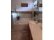 Bright bathroom with a tub, neutral tile, and sink at 227 Two Oaks Dr, Edgewater, FL 32141